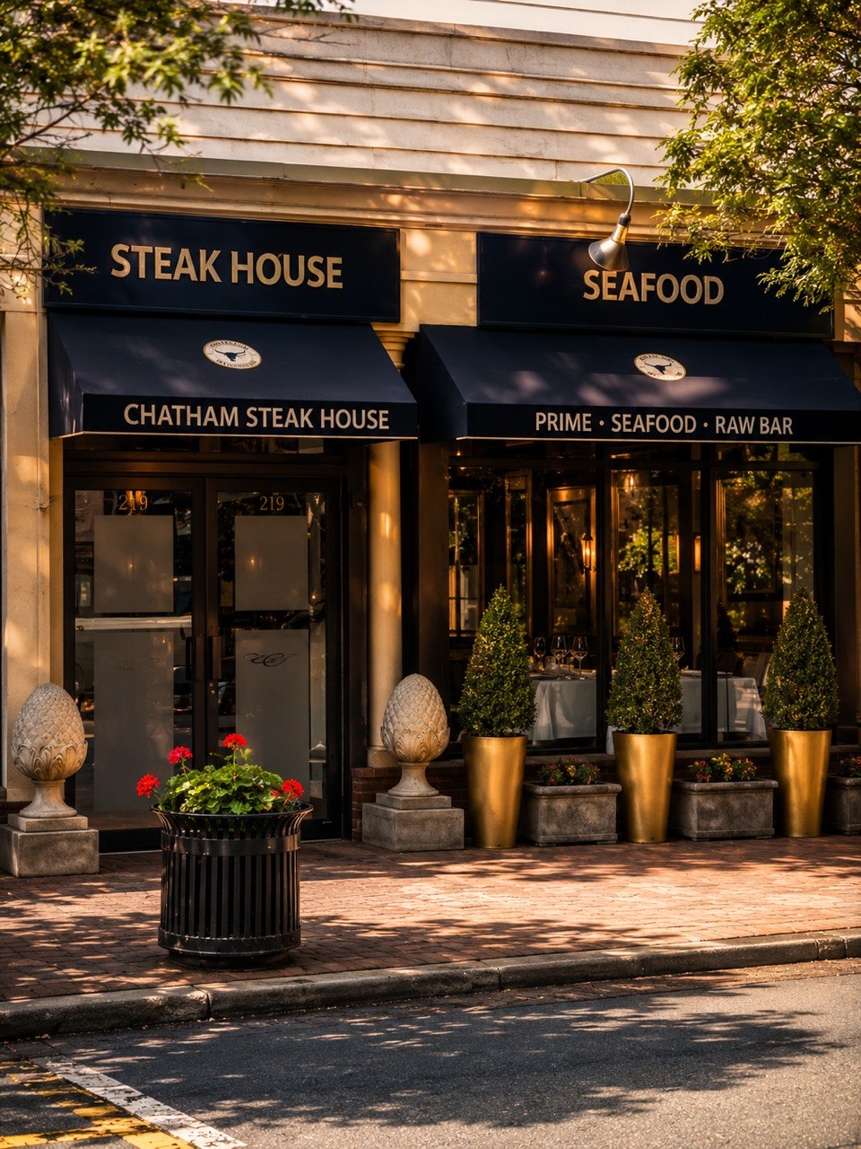 The Chatham Steakhouse storefront on Main Street, with navy awnings and brass planters